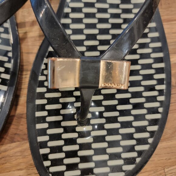 Coach Landon jelly flip flops in black with a gold bow and white pattern. - Picture 5 of 12